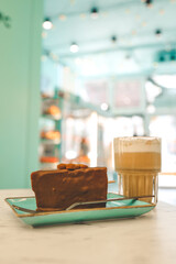 Chocolate cake and a cup of latte in a cozy coffee shop