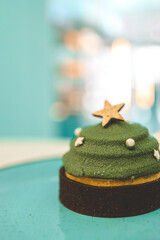 Christmas dessert in a cafe, cake in the shape of a Christmas tree