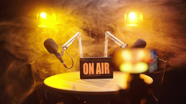 Refocus from dramatic podcast studio in smoke to smartphone recording 4K