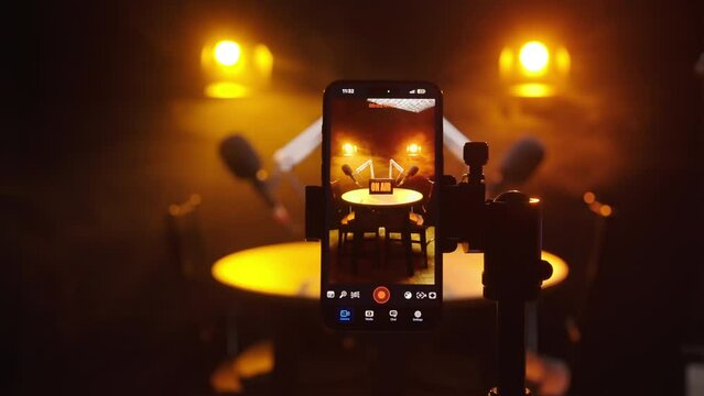 Smartphone recording vertical video of podcast studio 4K