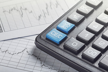 calculator and financial charts. Investment and capital accumulation concept