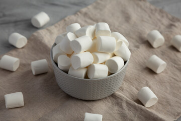 Fototapeta na wymiar White Marshmallows in a Bowl, side view.