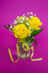 Bouquet of yellow roses on apurple background
