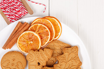 Gingerbread cookies, dried oranges, cookie painting, on a wooden background