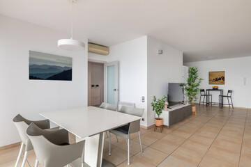 Dining table with chairs and TV in redesigned smart apartment