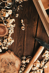 Wood background, carpenter tools, shavings, hammer - 702998393