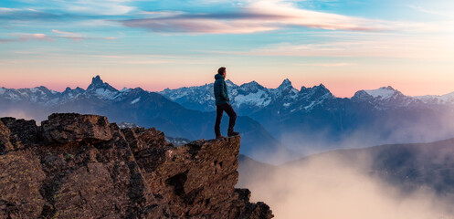 Adventure Hiker on Mountain Peak with Canadian Mountain Landscape in Background. - obrazy, fototapety, plakaty