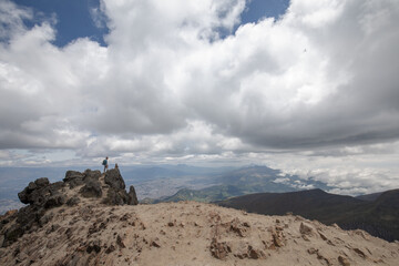 hiker on summit of volcano