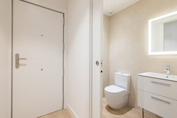 Fototapeta na wymiar Bathroom with sliding door separating toilet from corridor