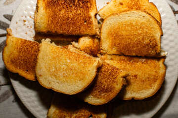 multiple pieces of toast on a white plate 