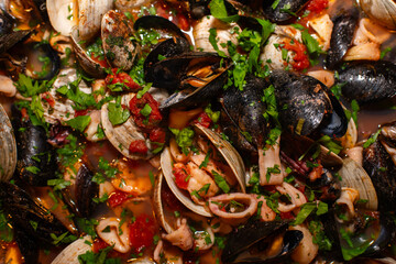Seafood Soup with tomato sauce and parsley 