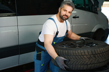 Experienced automotive service technician preparing to replace van tyres