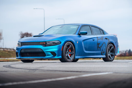 Brno, Czech republic - 31 December 2023: A blue Dodge Charger is parked in the parking lot. Fast luxury sports car. American muscle car with foil sticker.
