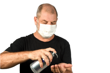 Portrait of a man, in a medical mask using alcohol gel. A concept of the danger of COVID-19 coronavirus for the elderly. on white background with space for text