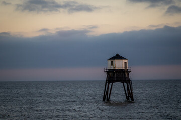 Lighthouse in the sea at sunset, Dovercourt low lighthouse at high tide built in 1863 and...