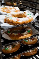 Bakery in the morning, hot fresh bread and pastry baking in the old town bakery, freshly baked products on shelves and the oven, small local business and food production