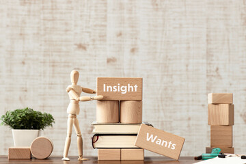 There is wood block with the word Insight or Wants. It is as an eye-catching image.
