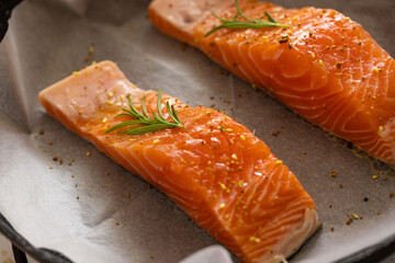 Pieces of trout (red fish) are fried in a pan with spices