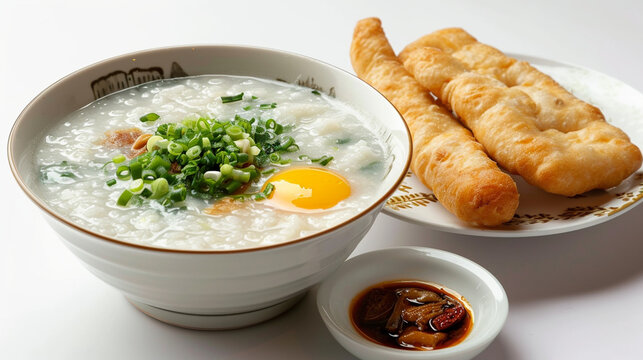 Front view fragrant congee rice porridge with boil egg and pork ball and frie dough stick white background and spotlight for advertise and presentation. Created using generative AI.