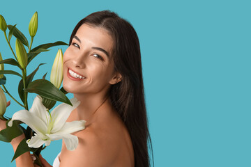 Beautiful young woman with white lily flowers on blue background, closeup