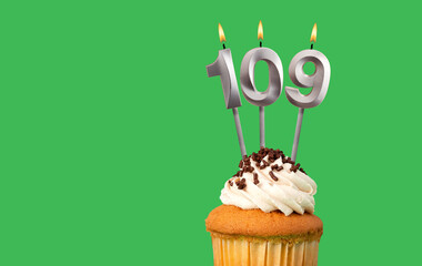 Birthday card with candle number 109 - Cupcake on green background