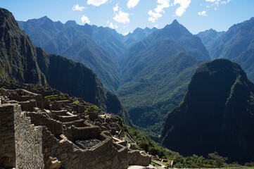 Fototapeta na wymiar Part of construction in Machu Picchu and Andes mountain range in the background