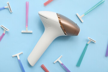 Composition with modern photoepilator and different razors on color background