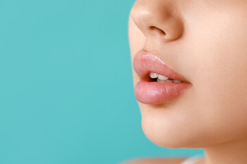 Lips of beautiful young woman on color background, closeup