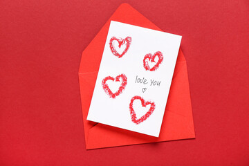 Greeting card with text LOVE YOU and envelope on color background. Valentine's Day celebration