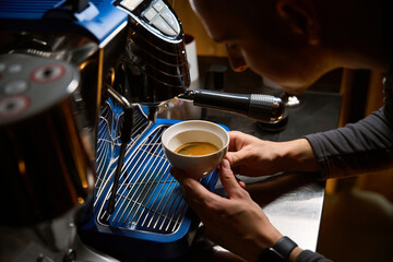 Coffeemaker brewing coffee in espresso machine in coffee shop