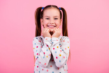Photo of lovely nice small girl with ponytails wear stylish sweatshirt hold arms under chin smiling...
