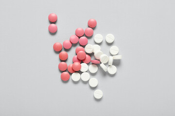 Pile of pills on grey background