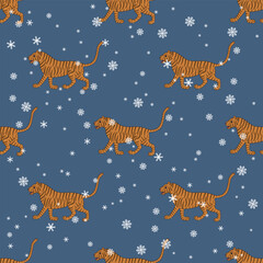 Fototapeta na wymiar Seamless seasonal winter pattern with walking tigers and snowflakes. Traditional animal design from India. On blue background.