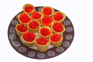 Tartlets with red caviar and butter on a plate isolate on a white background.