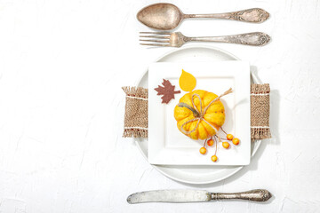 Autumn table setting. Thanksgiving cutlery, traditional fall decor. Cozy mood, minimalist design