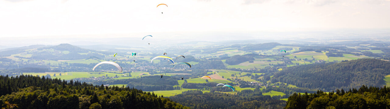 many paragliders in the air panorama