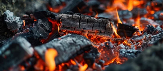 Foto auf Acrylglas Embers and ash intertwine in the hearth. Charcoal briquettes create a fiery backdrop. Bonfire cooking with coal. Barbecue ashes for outdoor food preparation. © 2rogan