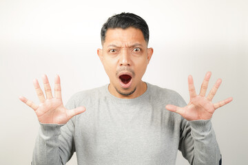 Fototapeta premium surprised, shocked expression of Asian Man with both fingers open, isolated background