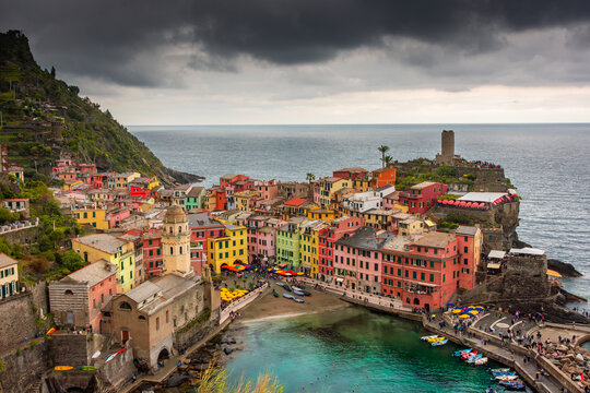 View of the colorful town of Vernazza under a cloudy sky, Cinque Terre, Liguria,  Italy