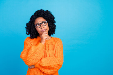 Photo portrait of lovely young lady look thoughtful empty space wear trendy knitwear orange garment...