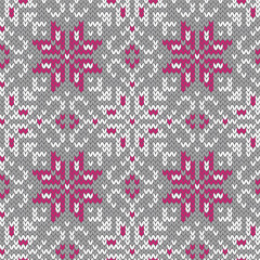 Knitted winter seamless pattern. Grey white and pink background. Vector illustration.