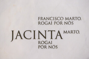 The tomb of Saint Jacinta Marto in the Basilica of Our Lady of the Rosary in Fatima, Portugal. "Rogai por nós" meaning "Pray for us" in Portuguese.