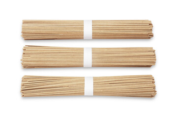 Uncooked buckwheat noodles (soba) isolated on white, top view