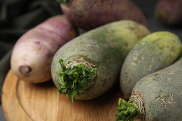 Green and purple daikon radishes on table, closeup