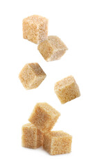 Cubes of brown sugar falling on white background