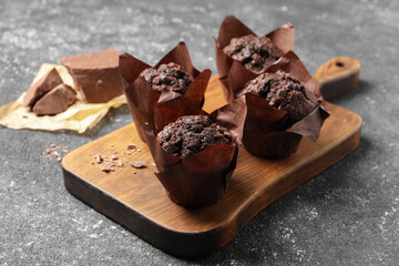 Tasty chocolate muffins on grey table, closeup