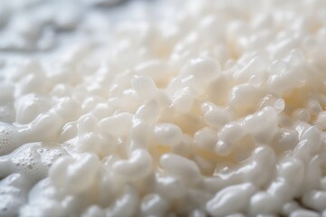 The shot reveals a generous serving of puffed rice cereal floating in a sea of frothy milk. The delicate rice grains cling to the surface, creating a picturesque texture that invites you