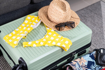 Packing swimwear into the travel bag to prepare for the trip