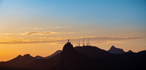 View from Sugar Loaf of Christ the Redeemer statue on Corcovado at sunset, Rio de Janeiro, Brazil.