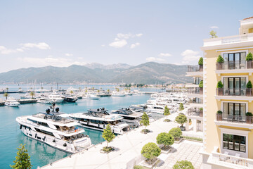 Expensive motor yachts are moored along the shore near the Regent Hotel. Porto, Montenegro